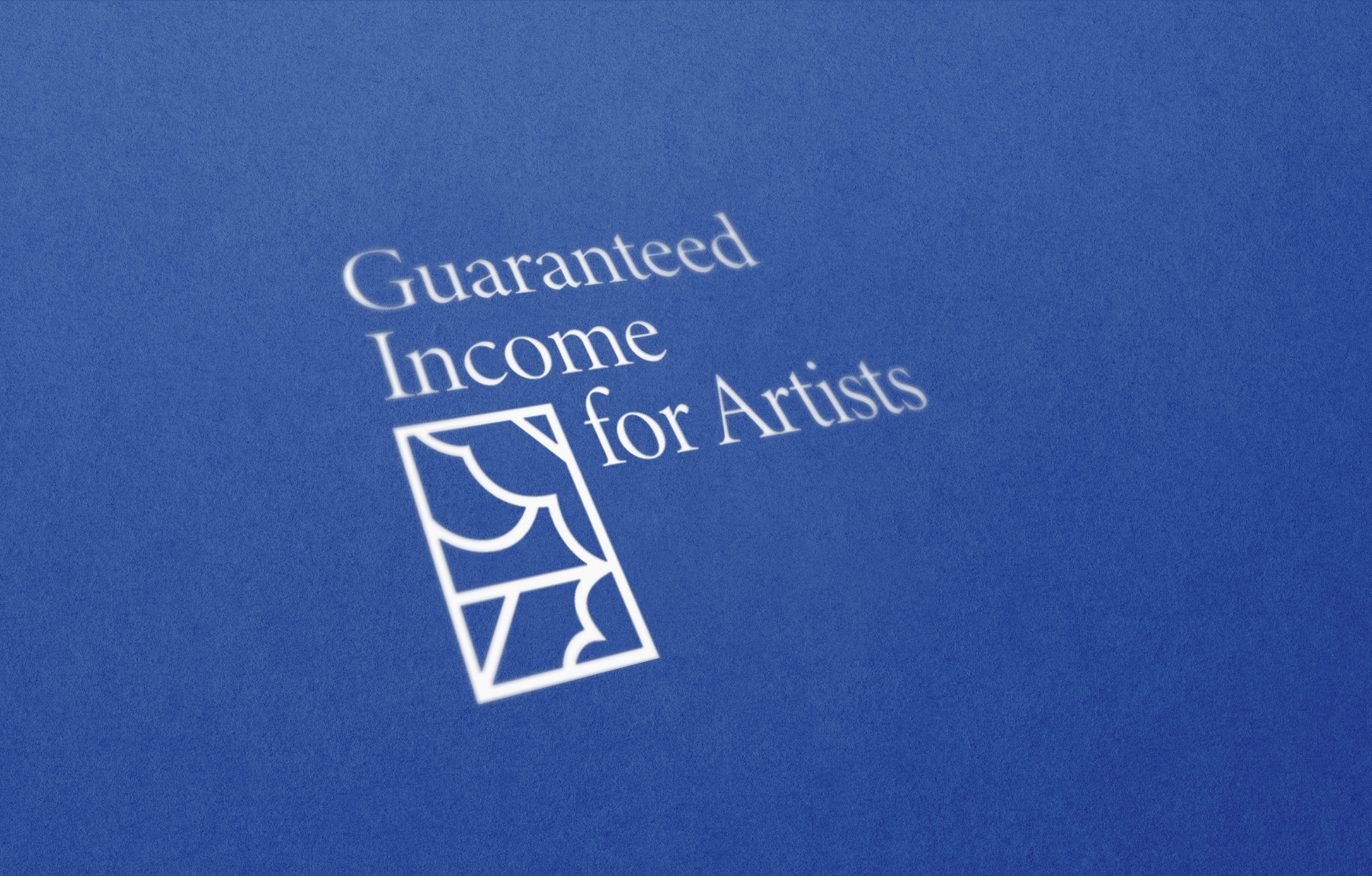 White graphic logo that says “Guaranteed Income for Artists” presented at an angle on a vivid blue background.