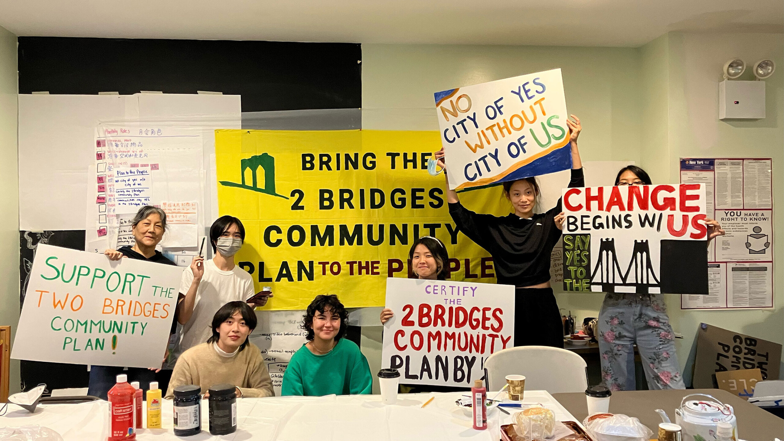 Group holding signs supporting the Two Bridges Community Plan.
