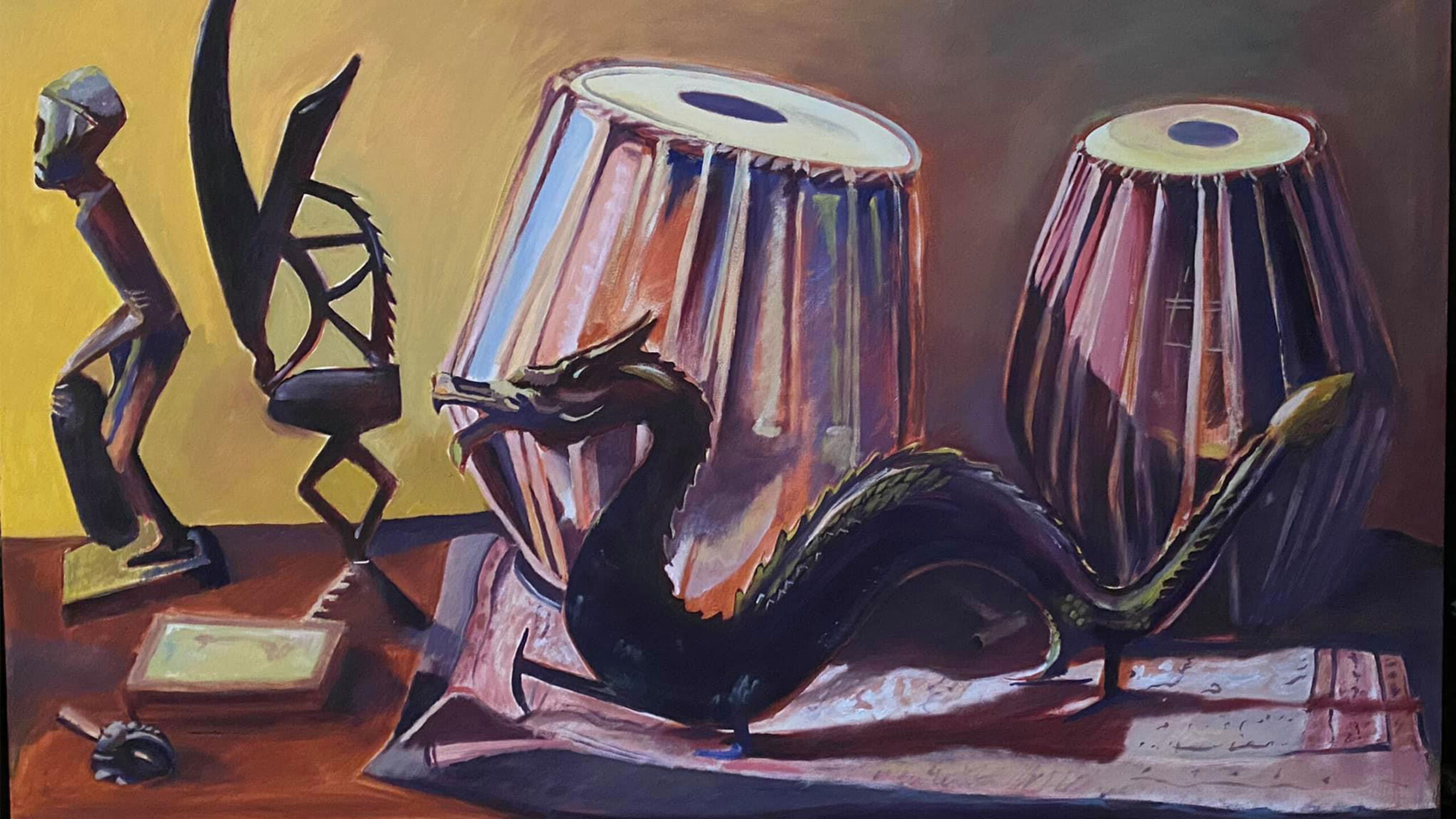 A rich array of cultural artifacts arranged on a surface creates a tableau of artistic expression. Two tablas, traditional Indian percussion instruments, dominate...