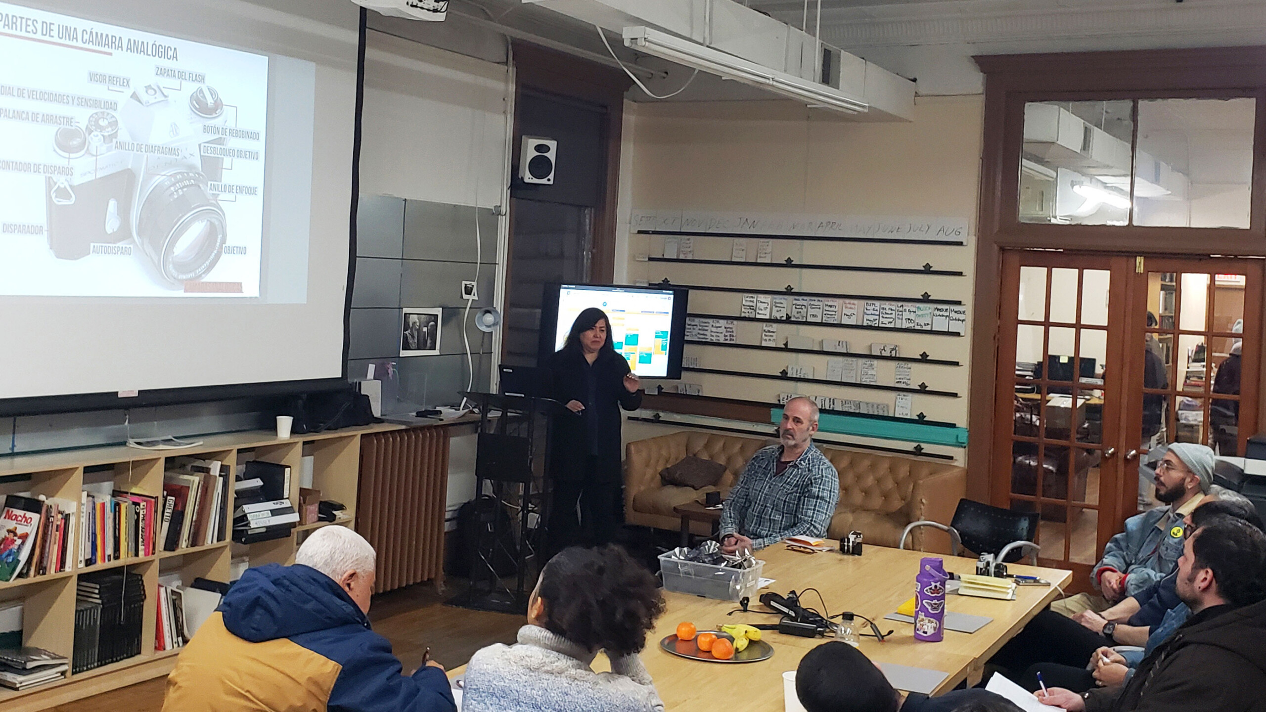 A photography workshop with a presentation on analog camera parts.