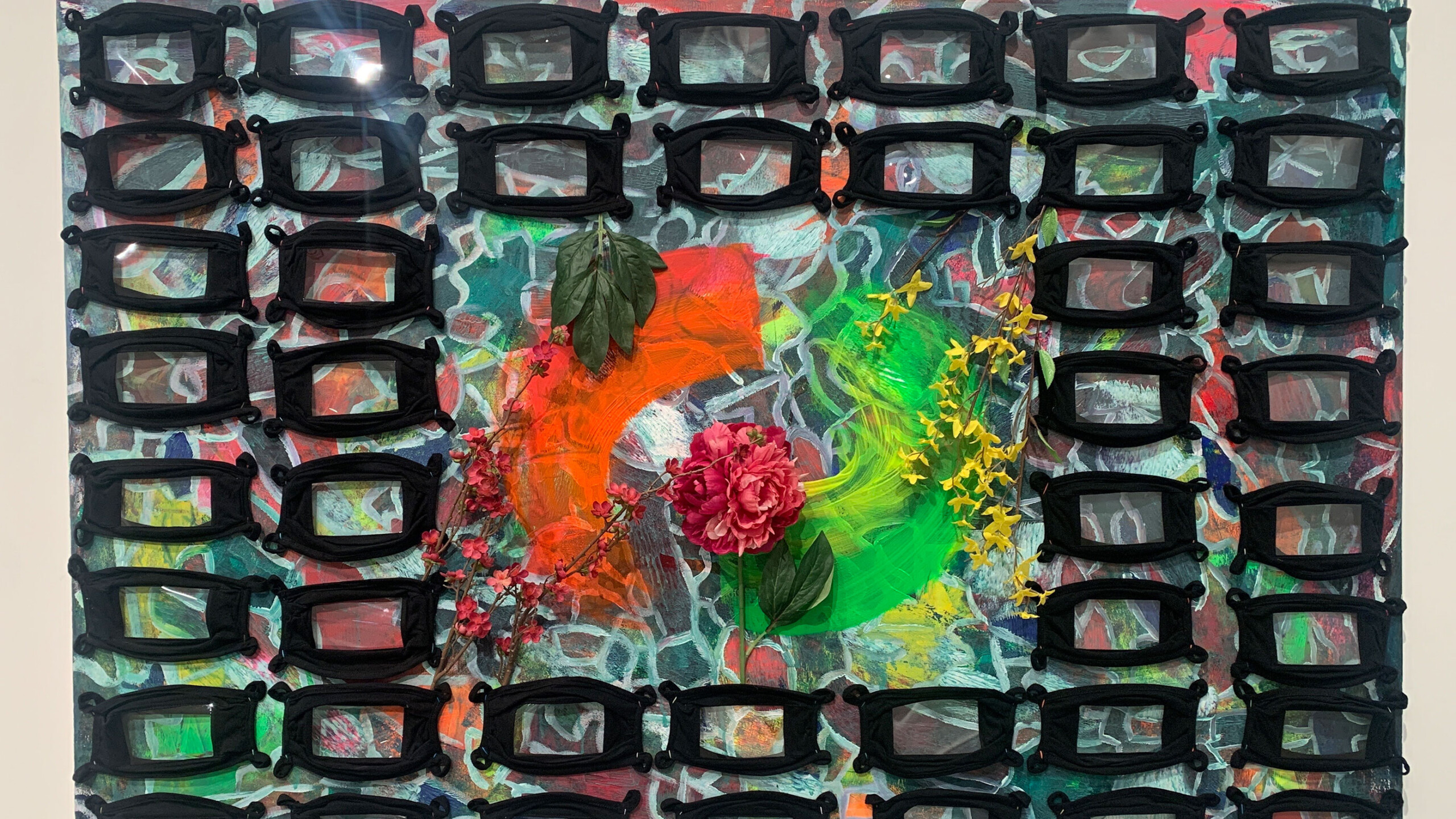 A colorful abstract artwork featuring a dynamic blend of colors and textures. At the center, vibrant hues of red, orange, green, and yellow swirl together, creating...