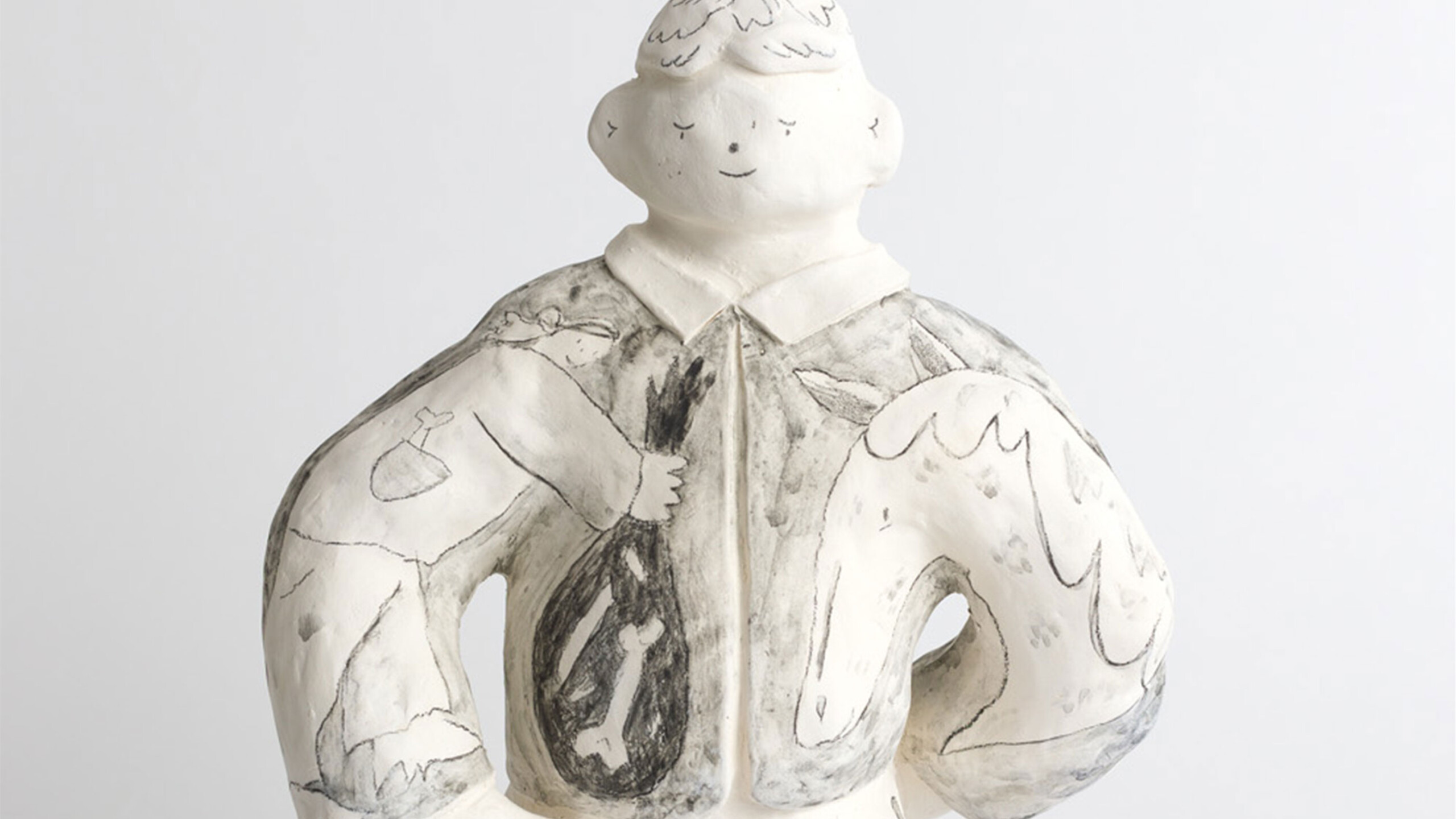 A ceramic sculpture of a figure, possibly human-like, characterized by a round and simplistic facial expression with closed eyes and a gentle smile. The figure...