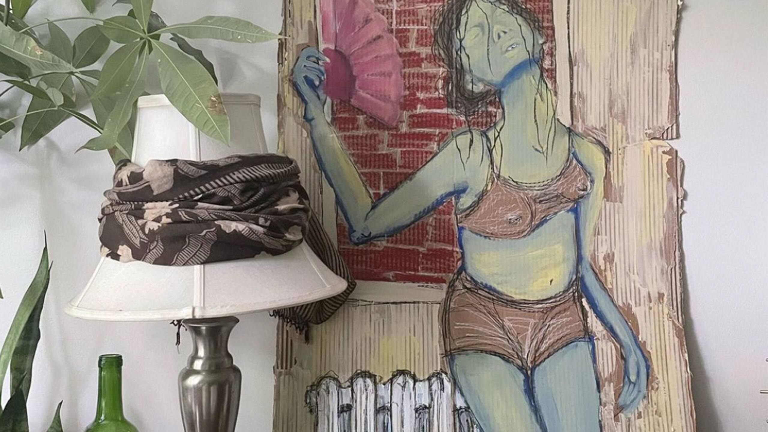 A creatively arranged indoor scene featuring a mix of objects and artwork. Dominating the composition, a life-sized cardboard cutout displays a stylized painting...