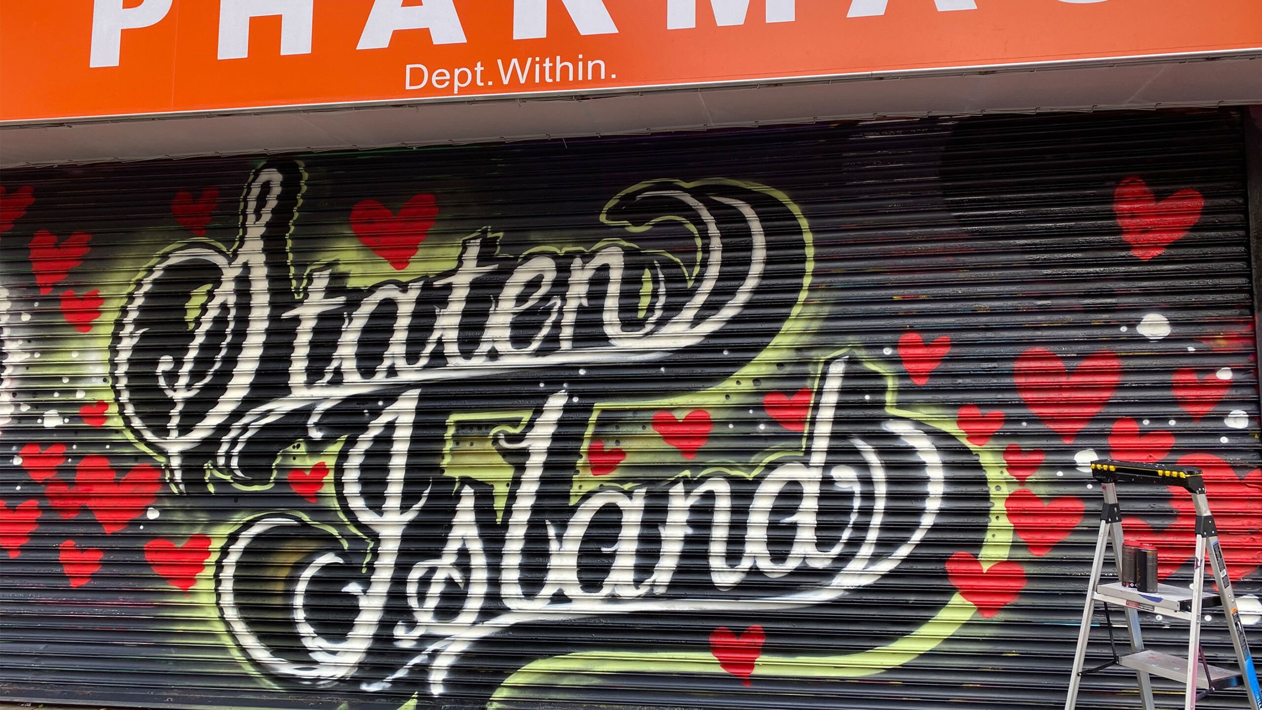 The image features a sign that prominently displays a bicycle as part of its design. The text appears to be partially obscured or distorted, with words like Pn,...