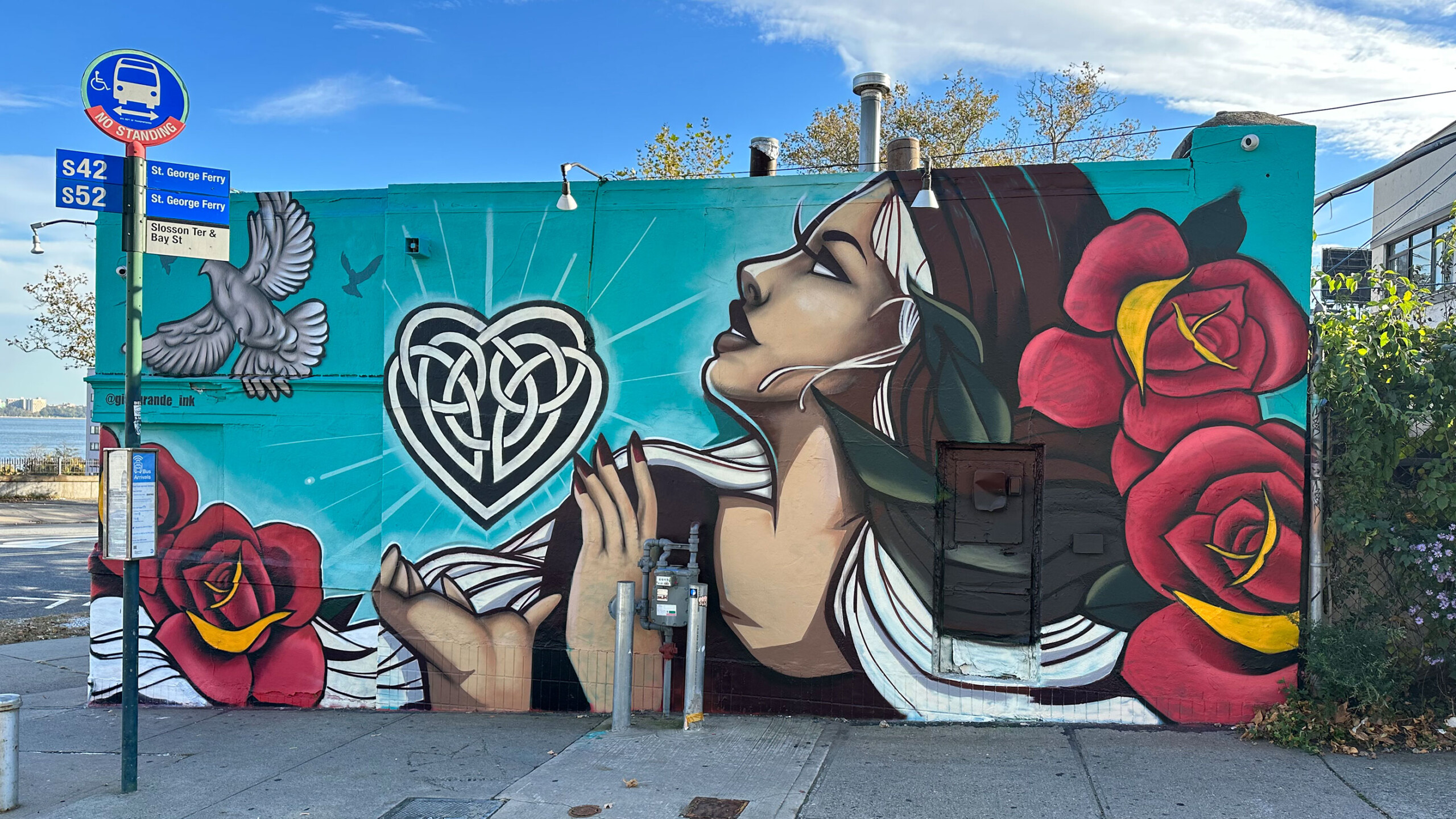 The image features a wall adorned with vibrant graffiti that showcases various artistic styles. The mural includes cartoon elements and colorful designs painted...